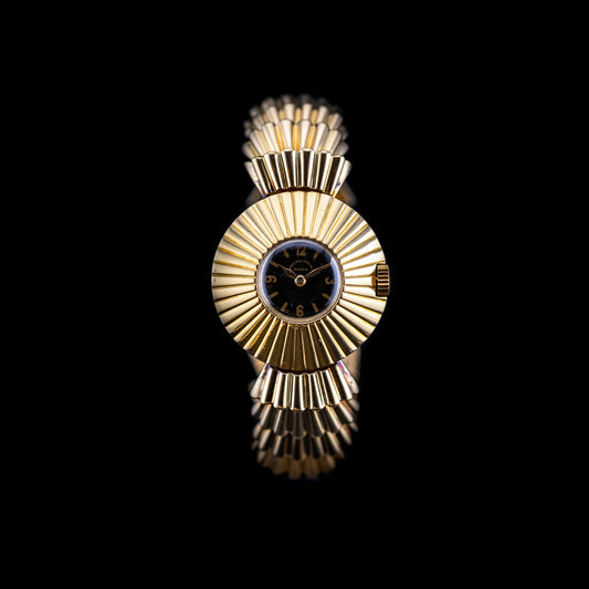 Montre Patek Philippe Épis de blé 1936 cadran bleu et boîtier or sculpté en soleil